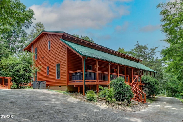 1707 Ridgecrest Dr, Sevierville, TN 37876 - view of front of home featuring metal roof, central AC unit, faux log siding, and stairs