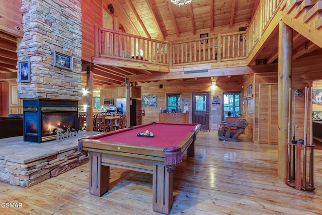 1707 Ridgecrest Dr, Sevierville, TN 37876 - recreation room with high vaulted ceiling, wooden ceiling with exposed beams, wood-type flooring, wooden walls, and a stone fireplace