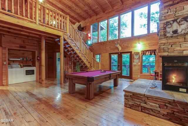 1707 Ridgecrest Dr, Sevierville, TN 37876 - recreation room featuring washing machine and dryer, high vaulted ceiling, wooden ceiling with exposed beams, french doors, and wooden walls