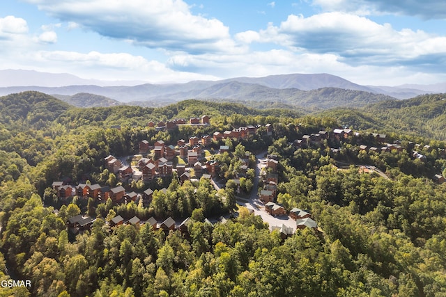 aerial view with a wooded view and a mountain view