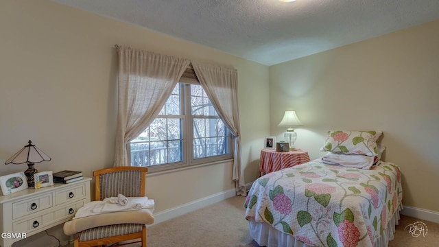 bedroom featuring light carpet and a textured ceiling