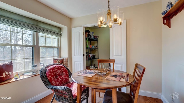 dining area featuring an inviting chandelier and wood-type flooring