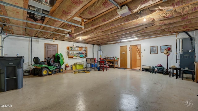 garage with a garage door opener and water heater