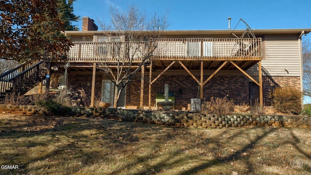 back of house with a wooden deck and a yard