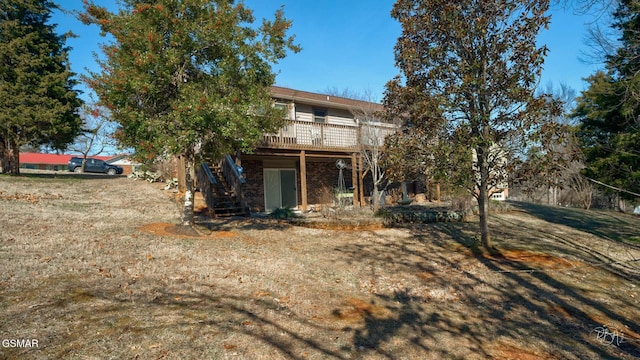 rear view of house featuring a deck