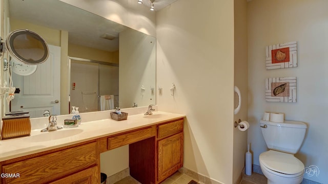 bathroom with an enclosed shower, vanity, tile patterned floors, and toilet