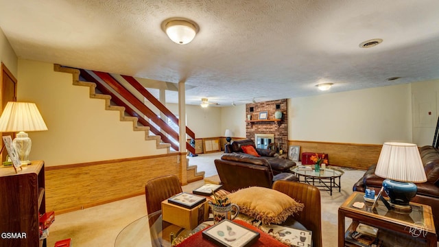 carpeted living room with a fireplace and a textured ceiling