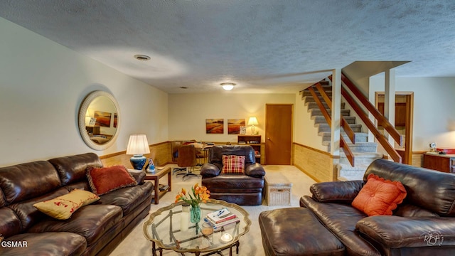 carpeted living room featuring a textured ceiling