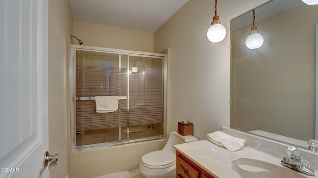 full bathroom featuring toilet, vanity, and bath / shower combo with glass door