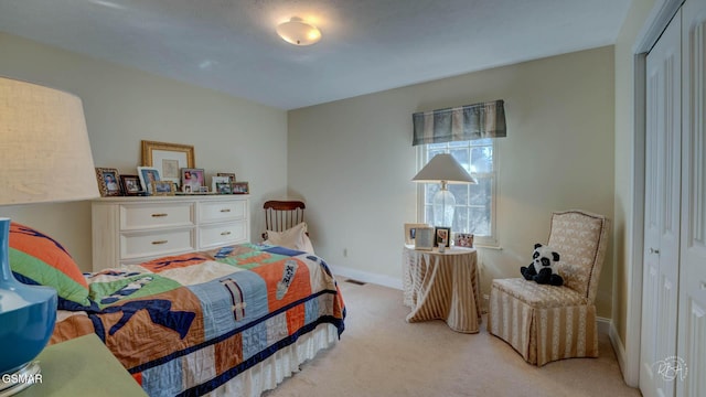 bedroom with light colored carpet and a closet