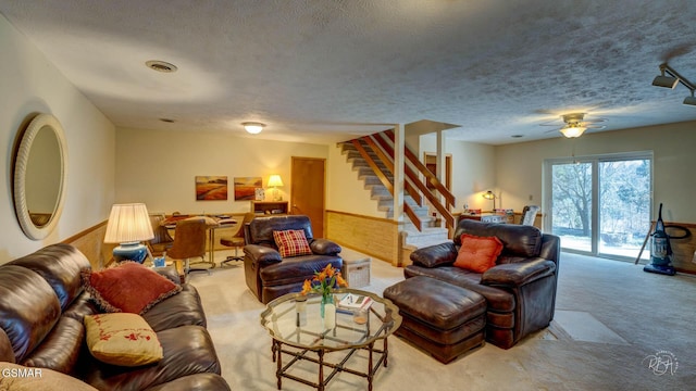 living room featuring light colored carpet and a textured ceiling