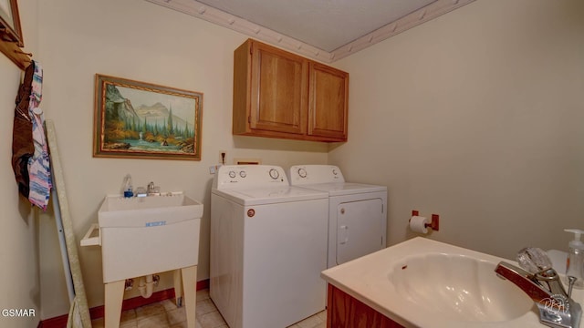 clothes washing area featuring crown molding, cabinets, separate washer and dryer, and sink