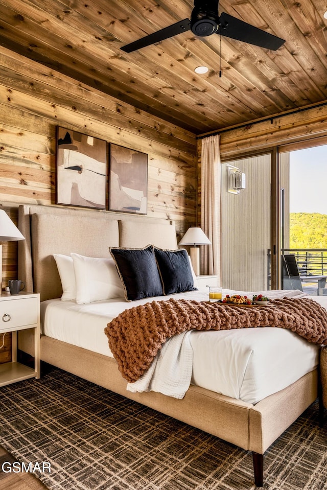 bedroom featuring ceiling fan, access to exterior, wooden ceiling, and wooden walls