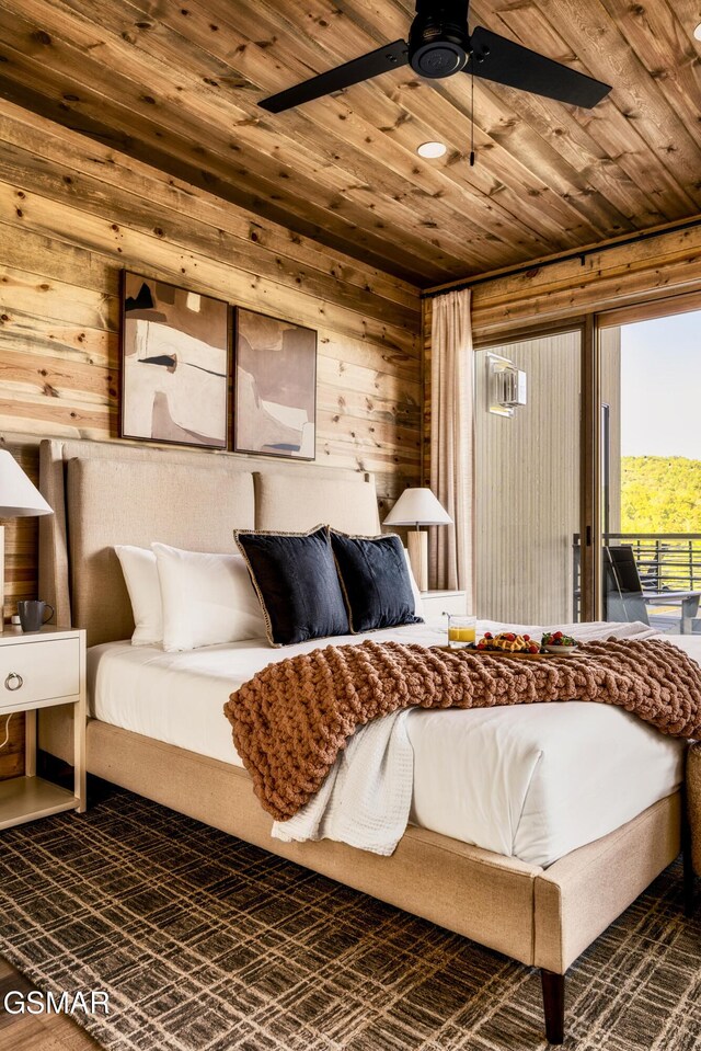 bedroom with wooden ceiling, wooden walls, and access to exterior