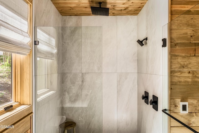 bathroom featuring a healthy amount of sunlight, walk in shower, and wooden ceiling