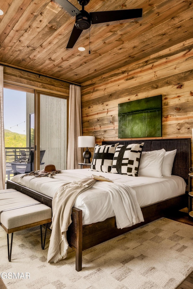 bedroom featuring ceiling fan, wood walls, and wooden ceiling