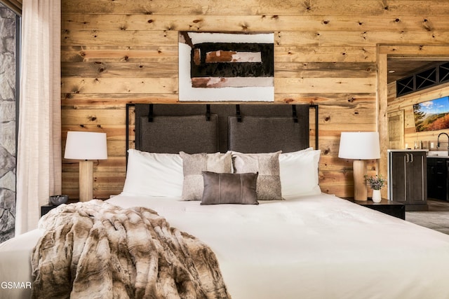 bedroom featuring wood walls