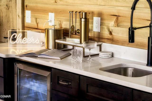 kitchen with beverage cooler, light countertops, and a sink