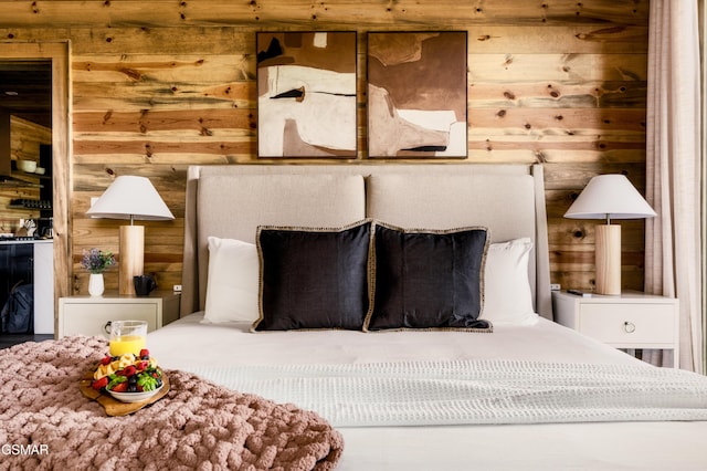 bedroom featuring wood walls