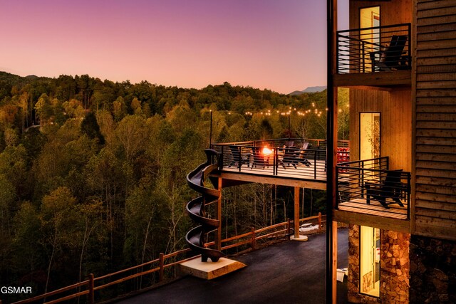 back house at dusk with a balcony