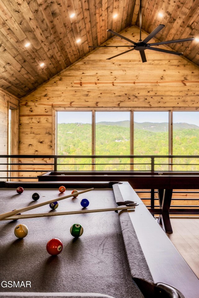 playroom featuring vaulted ceiling, wood ceiling, and wood walls