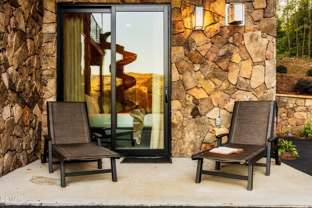 bedroom with access to outside, multiple windows, wooden walls, and wood ceiling