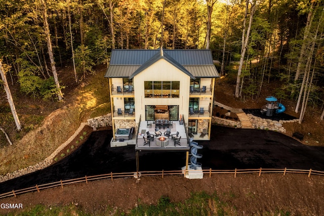 rear view of property with a balcony