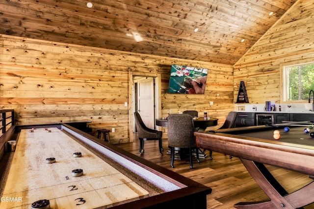 recreation room with wooden walls, wood ceiling, wood finished floors, pool table, and vaulted ceiling