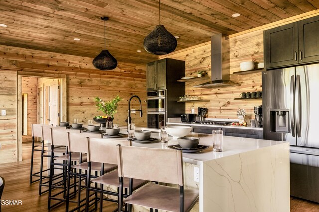 dining space featuring a notable chandelier, a towering ceiling, wooden walls, wood ceiling, and hardwood / wood-style flooring