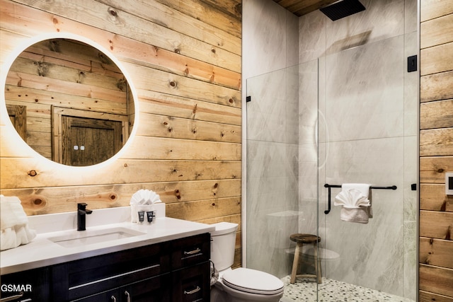 bathroom featuring vanity, wood walls, toilet, and a shower with door