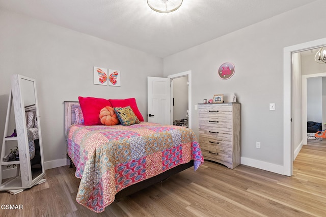 bedroom featuring baseboards and wood finished floors