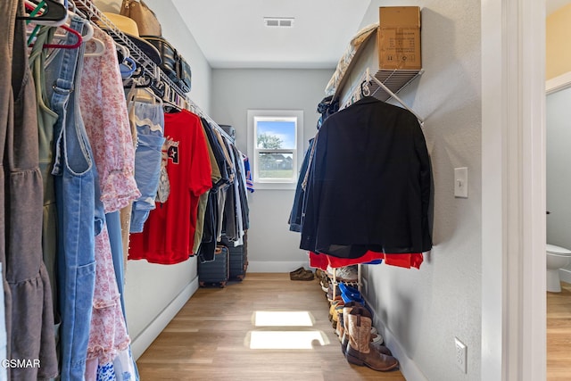 walk in closet featuring light wood-style floors and visible vents