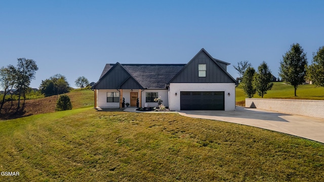 modern farmhouse with driveway, brick siding, board and batten siding, and a front lawn