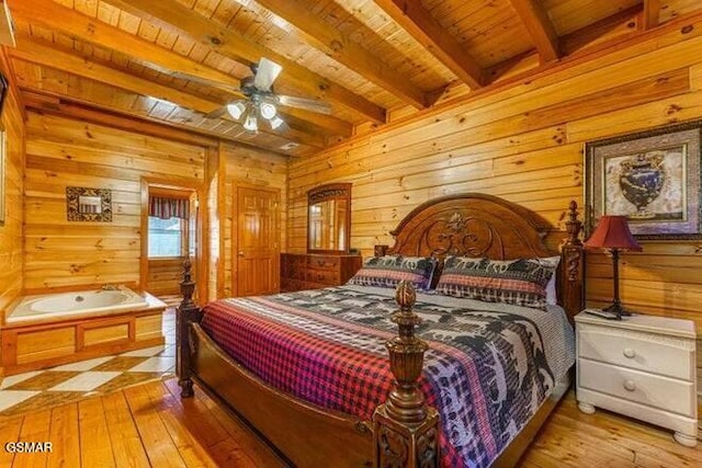 bedroom with beamed ceiling, light hardwood / wood-style flooring, ceiling fan, and wood ceiling