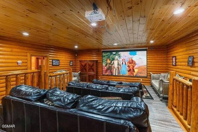 home theater room with rustic walls and light hardwood / wood-style floors