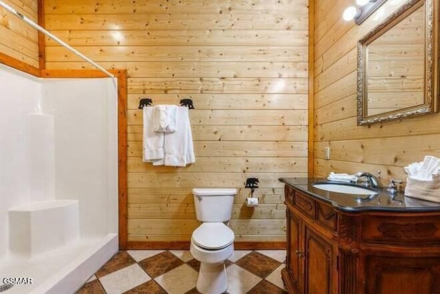 bathroom featuring vanity, walk in shower, and wood walls