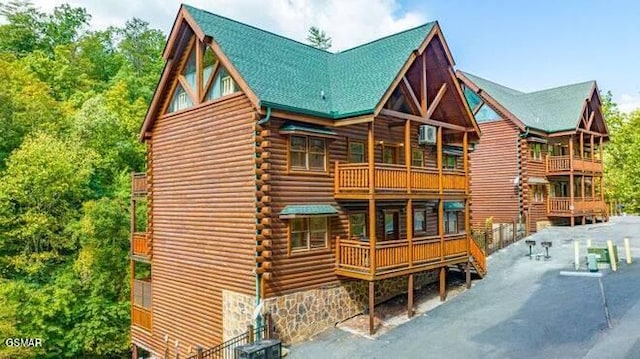 back of house featuring a balcony