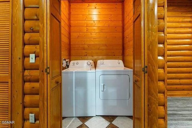 washroom featuring separate washer and dryer and rustic walls