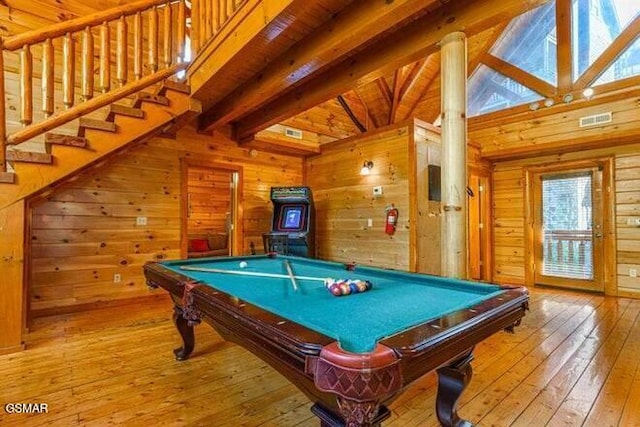 playroom featuring light wood-type flooring, wood ceiling, wooden walls, beam ceiling, and pool table