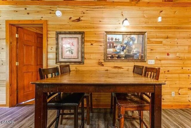 dining area featuring dark wood-type flooring