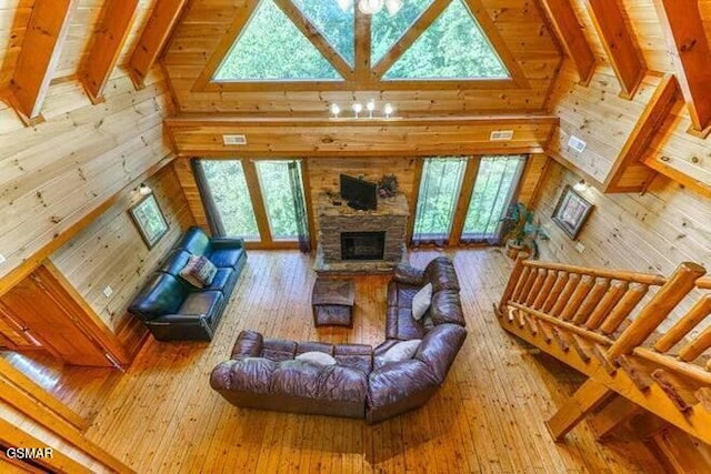 living room with beam ceiling, high vaulted ceiling, and wood-type flooring