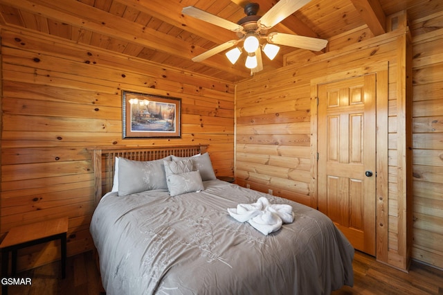 bedroom featuring beamed ceiling, dark hardwood / wood-style floors, wooden ceiling, and wooden walls