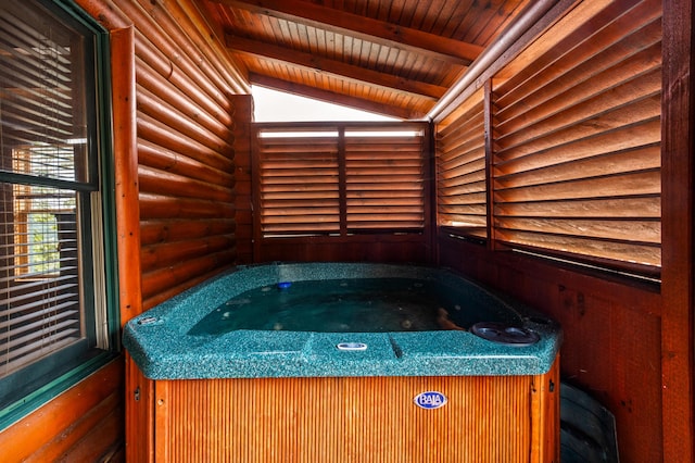 misc room featuring a hot tub, wooden ceiling, log walls, and lofted ceiling with beams