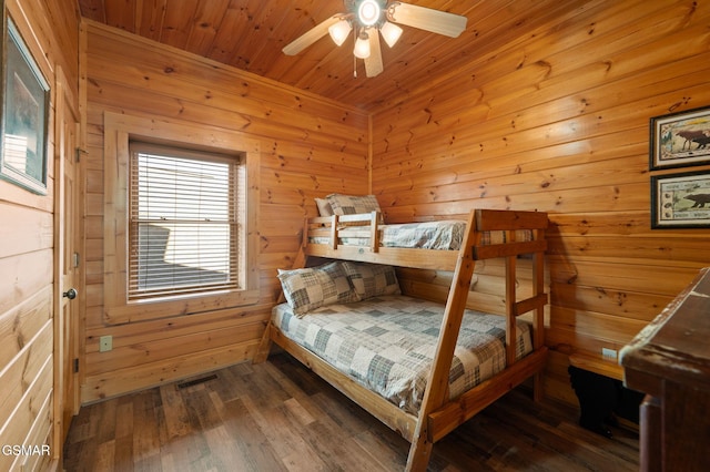 bedroom featuring dark hardwood / wood-style floors and wood ceiling