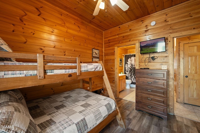 bedroom with wood-type flooring, wooden ceiling, and wood walls