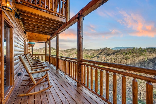 deck at dusk featuring a mountain view