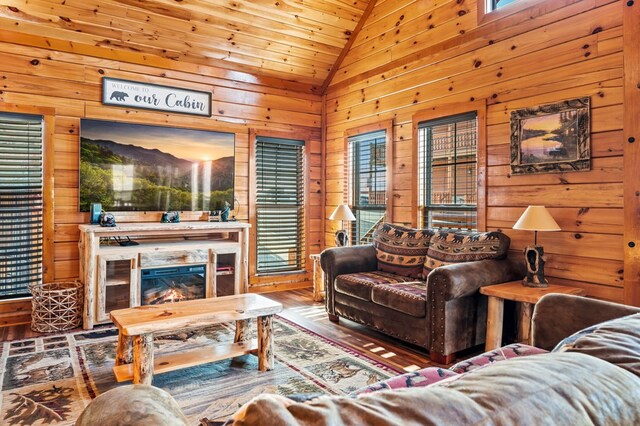 living room with plenty of natural light, wooden ceiling, hardwood / wood-style floors, and wood walls