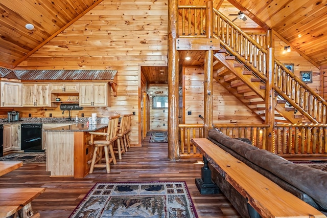 interior space featuring high vaulted ceiling, dark wood-type flooring, wooden walls, and wooden ceiling