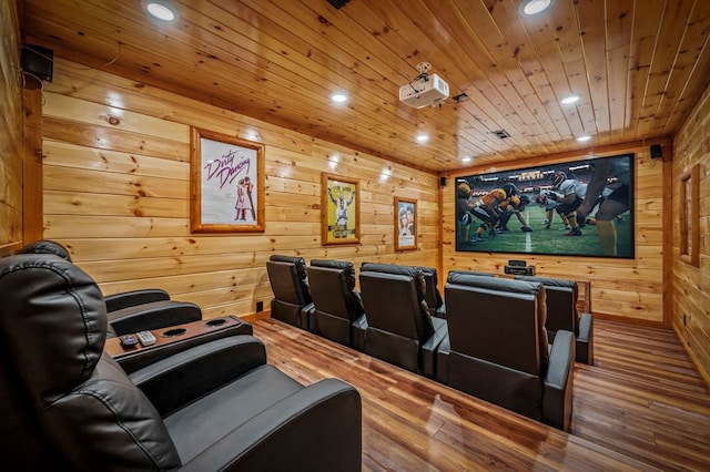 cinema room featuring hardwood / wood-style floors, wood ceiling, and wooden walls