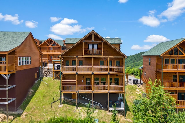 back of house featuring a balcony